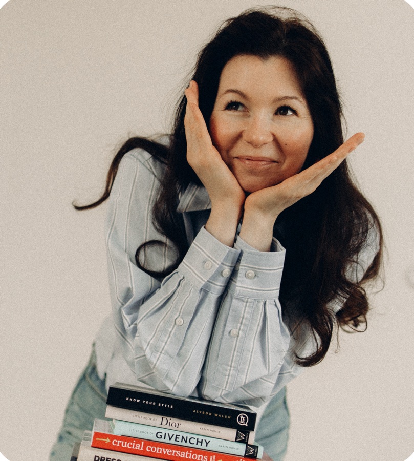 Karina leaning on a stack of design books